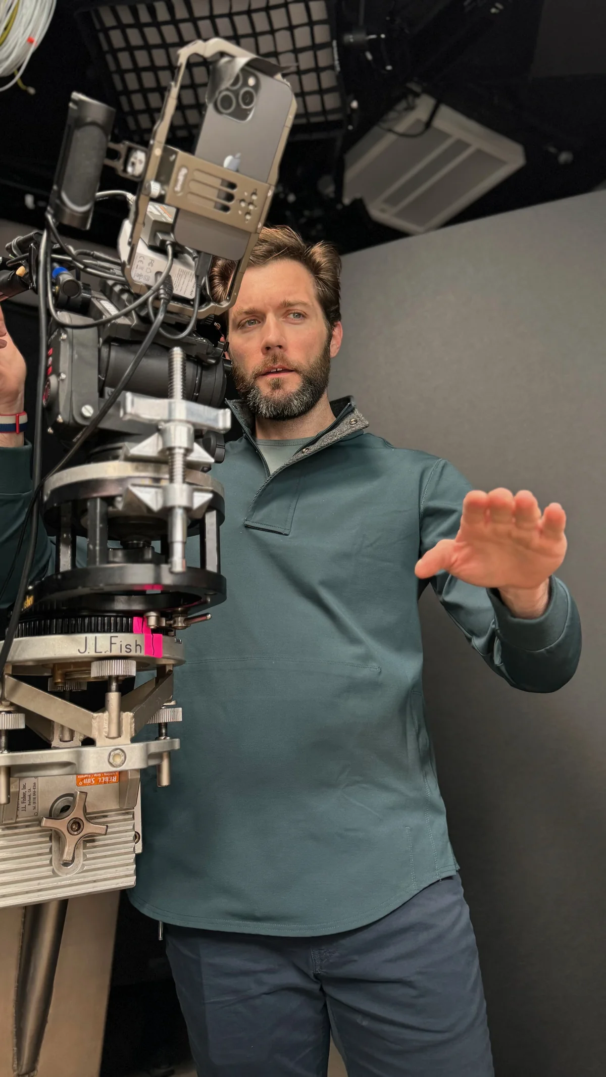 On set beside a cinema camera, guiding the next shot.
