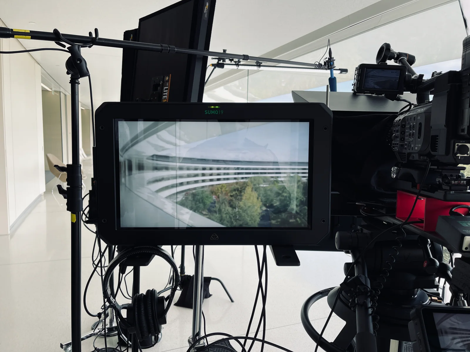 A production monitor framing the curved architecture of Apple Park.