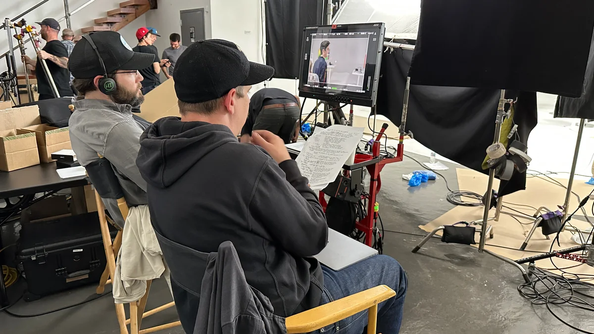 The creative team reviewing the script and monitor on set.