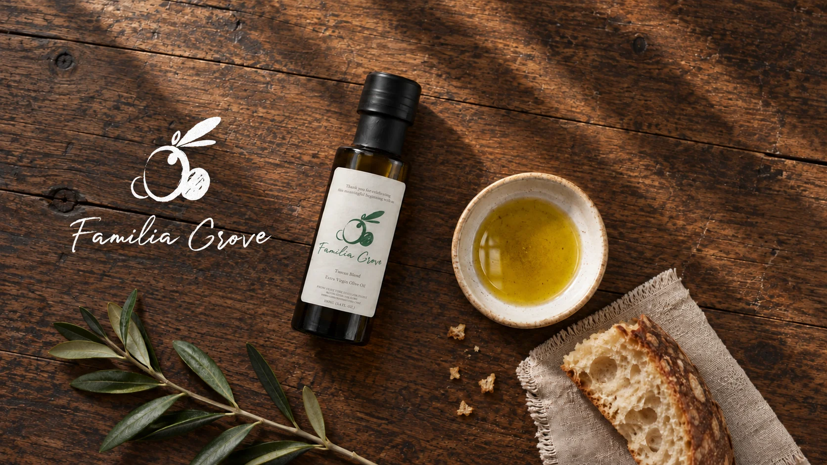 Familia Grove olive oil with bread and an olive branch on a wooden table